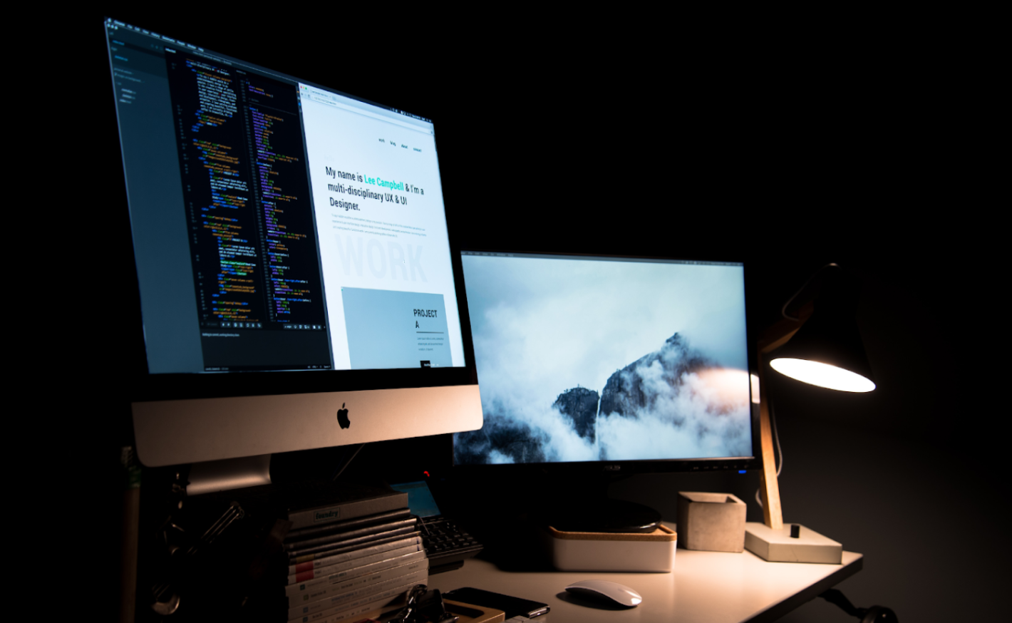 Computer screens on a desk in the dark, open source design